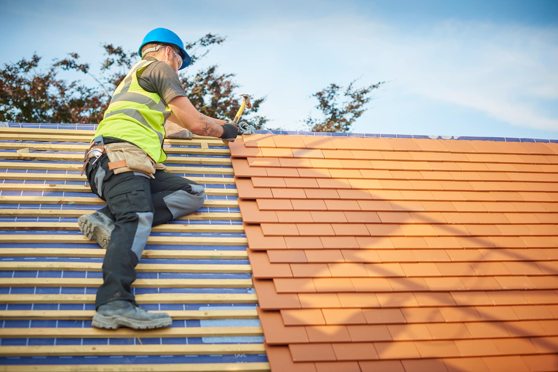 Roofer completing a new tiled roof